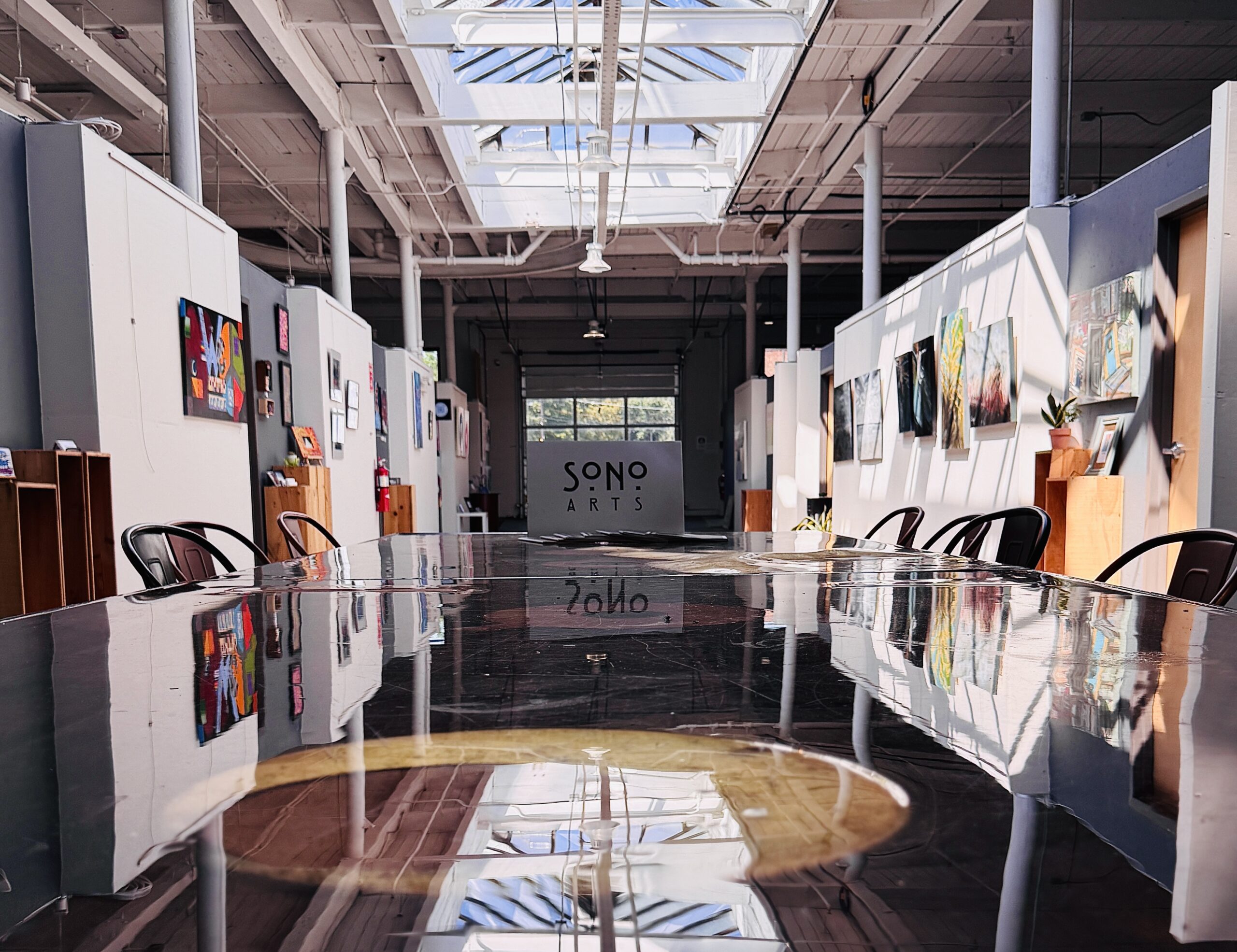 Handcrafted artist table at NSC’s Creative Way hallway, reflecting light and creativity in the studios
