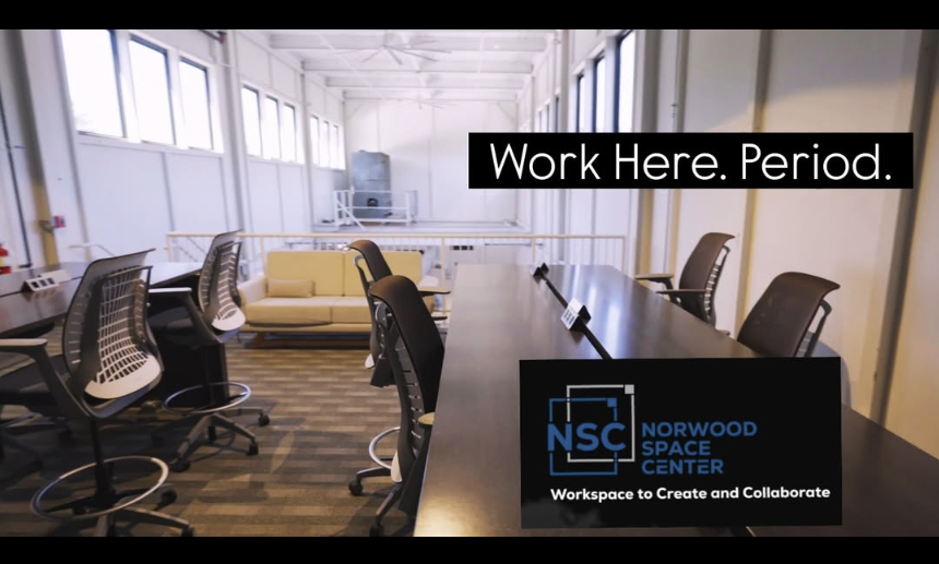 Coworkers at NSC using laptops in shared workspace with caption “Work Here. Period.”
